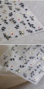 Macro detail of M653 nail stickers with gold foil bamboo and butterfly calligraphy art