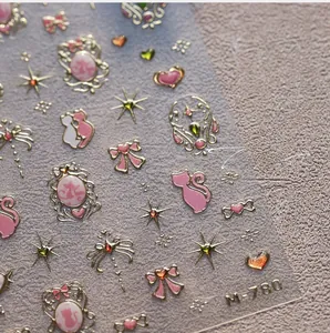 Macro view of M-780 5D embossed nail stickers featuring pink hearts and gold cat motifs