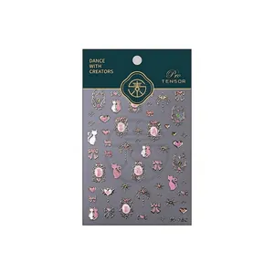 Pink and gold nail stickers set featuring cats and bows with a retail display card