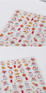 Close-up of 3D embossed Chinese New Year nail art stickers with lion dance and koi motifs