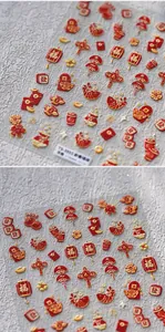 Dettaglio degli adesivi per nail art 3D in rilievo con lanterne e buste rosse portafortuna