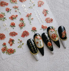 Macro detail of 3D embossed red peony nail stickers with golden outlines and floral motifs