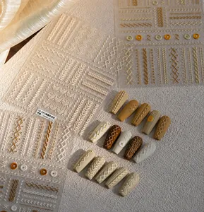 Macro shot of 3D sweater knit relief nail art stickers with vintage pattern details