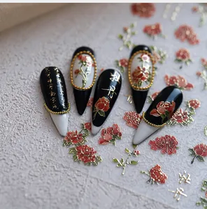 Macro detail of Chinese style nail stickers featuring golden peony flowers and calligraphy