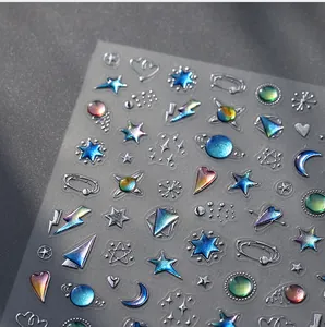 Macro detail of 3D embossed nail stickers featuring holographic star and moon patterns