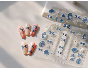 Detail of TL-312 nail stickers featuring blue bows, lace patterns, and 3D pearl texture