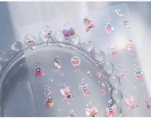 Macro detail of laser iridescent nail stickers with butterfly and strawberry patterns