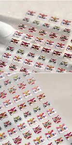 Detail of matte lion dance nail art stickers with silver stamping and festive designs