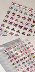 Macro detail of Chinese lion dance nail stickers with 3D embossed texture and gold accents
