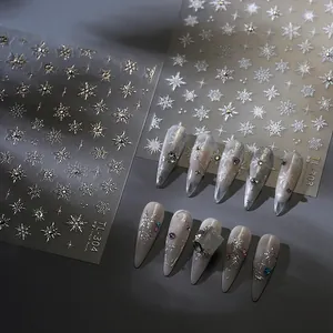 Silver metallic snowflake nail stickers with starburst patterns for winter nail art designs