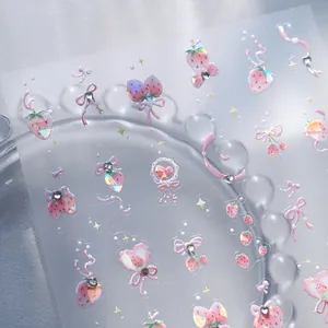 Holographic strawberry and bow nail art stickers with clear adhesive and mini rhinestones