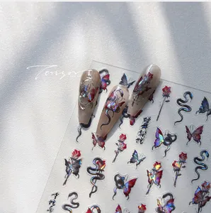 Detailed holographic nail stickers featuring butterflies, roses, and snakes with 3D effect