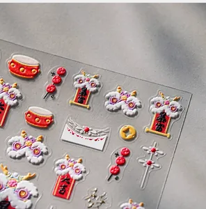 Detailed macro view of 3D embossed Chinese New Year nail stickers with lion dance and scroll