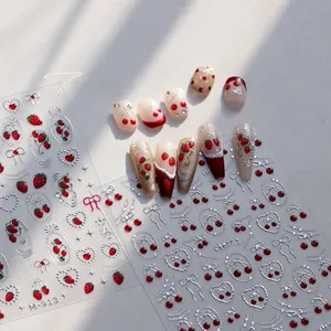 Macro shot of M-913 nail stickers featuring silver bows and red cherry patterns