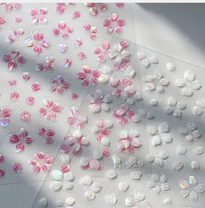 Dettaglio macro di adesivi per unghie 3D a rilievo fiori di ciliegio rosa e bianchi