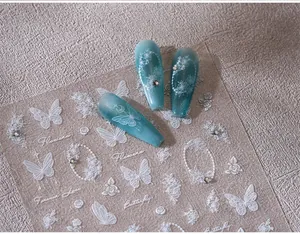 Macro detail of transparent butterfly and floral nail stickers with glitter accents