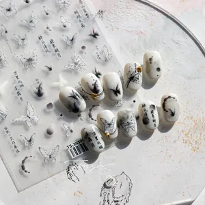 Macro detail of 5D embossed ink butterfly nail stickers with artistic calligraphy