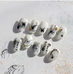 Macro view of 5D embossed ink butterfly nail art stickers with elegant calligraphy