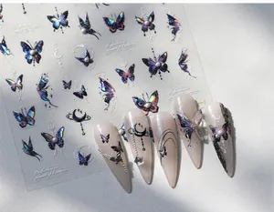 Macro detail of iridescent butterfly nail decals with 3D aurora effect and chrome stars