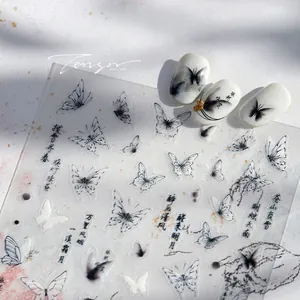 Close-up of 5D embossed nail stickers featuring ink butterfly and Chinese calligraphy art