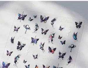 Detail of 3D laser butterfly nail decals with iridescent finish and pearl accents
