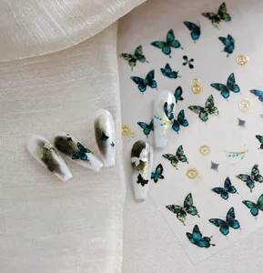 Steampunk gold foil butterfly nail stickers featuring teal gears and cosmic star patterns