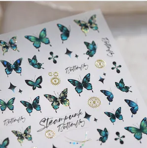 Detail of steampunk butterfly nail stickers with turquoise wings and golden gears