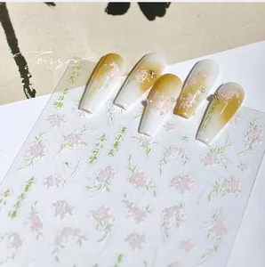 Detail of 3D floral nail stickers with Chinese calligraphy and pink flower patterns