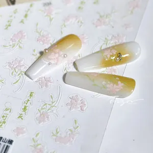 Macro detail of floral nail art stickers with 3D pearls and matte gradient finish