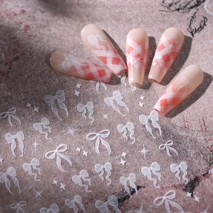 5D embossed nail stickers featuring white bow designs and pink gradient star patterns