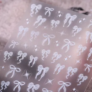 5D embossed nail stickers featuring white bowknots and stars on a transparent sheet