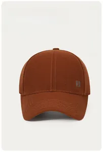 Detail of brown cotton baseball cap featuring high-density embroidery and reinforced brim