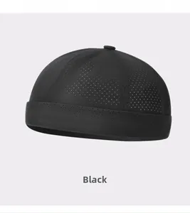 Close-up of black breathable mesh fabric on a minimalist docker brimless cap