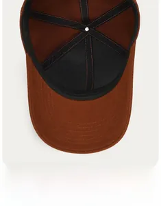 Detail view of the brown baseball cap interior with sweatband and stitching texture