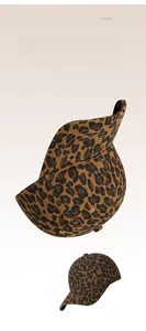 Detail of distressed brim and leopard print fabric on a canvas baseball cap
