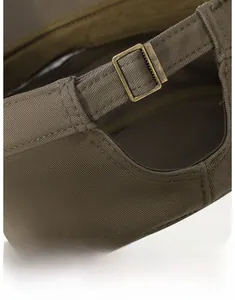 Detail of army green twill cotton baseball cap with vintage bronze metal buckle adjustment