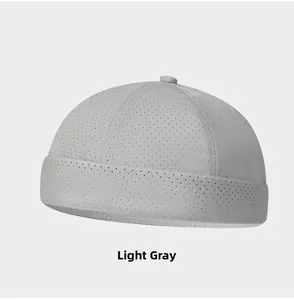 Detail view of light grey mesh docker hat showing breathable perforated fabric texture