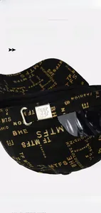 Detail of black baseball cap back with gold prints and adjustable silver buckle
