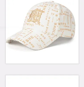 Detailed close-up of white baseball cap with brown letter print and 3D floral embroidery
