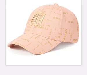 Detail view of pink baseball cap with 3D gold embroidery and all-over letter print