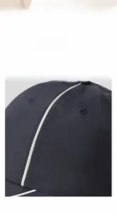 Detail of breathable quick-dry fabric and white decorative stripe on a navy baseball cap