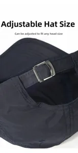 Close-up of adjustable metal buckle and textured quick-dry fabric on navy baseball cap