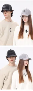 Detail of couple wearing quick-dry baseball caps with Travel Californian embroidery