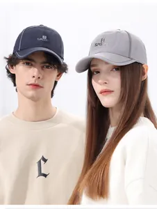 Close-up of quick-dry sports caps in navy and grey with breathable mesh fabric