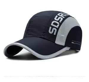 Detail of navy blue quick-dry baseball cap featuring gray mesh panels and sport branding