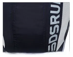 Close-up of the breathable mesh panels and silver reflective lettering on navy sports cap
