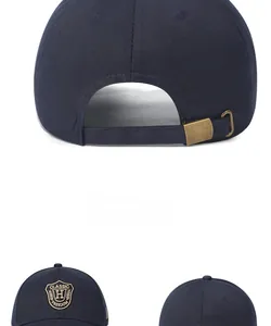 Detail of navy cotton baseball cap showing the adjustable metal buckle and embroidery