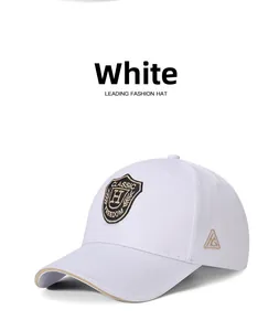 Close-up of shield embroidery and khaki sandwich brim on white cotton baseball cap