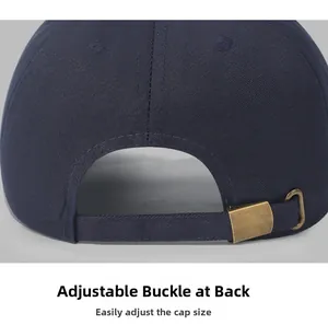 Detail of adjustable bronze metal buckle on navy cotton baseball cap for custom fit