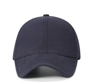 Macro shot of navy blue cotton baseball cap showing stitch detail and twill fabric texture
